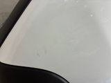 a white car that has been painted white and has a black trim
