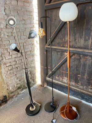 two lamps that are standing next to each other on the floor