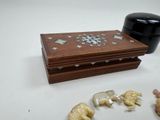 a small wooden box that has some small figurines on it