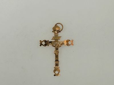 gold plated cross on a white surface with a cross on it