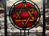 a stained glass window with a star of david on it