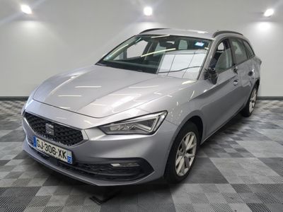 the grey car is parked on a checkered floor in a garage