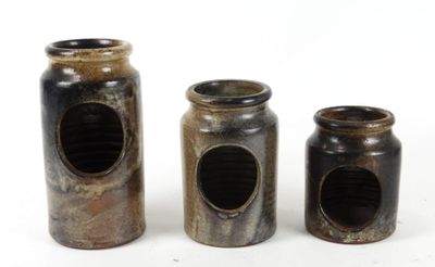 three jars that are sitting next to each other on a table