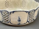 a bowl with a sailboat on it on a table