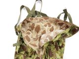 a camouflage bag that is sitting on a white surface