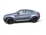 the bmw x6 suv is parked on a white surface