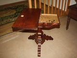 a small wooden table with a drawer on top of it