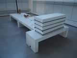 a white bench that is sitting in a room