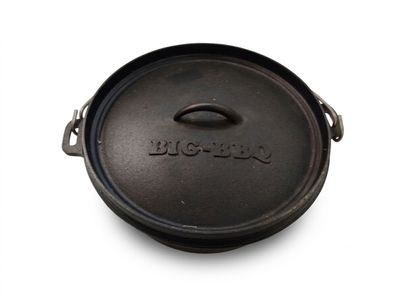 an old cast iron skillet with a lid on a white surface