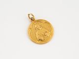a gold coin with a woman ' s face on it