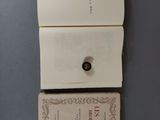 two books on the table and one has a button on it
