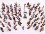 a lot of figurines that are on a white surface