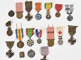 an assortment of medals and medals are arranged on a white surface