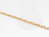 a close up of a gold chain on a white background