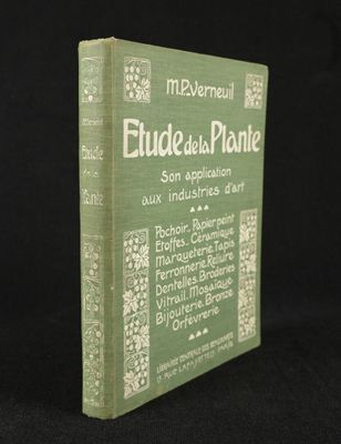 an old book sitting on top of a black table next to a black background