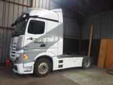 a white truck that is parked in a garage