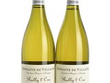 two bottles of white wine sitting next to each other on a white surface
