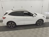 a white car is parked in a garage with a checkered floor