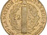 a gold coin with a tall tower on it