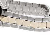 a close up of a watch on a silver and gold bracelet