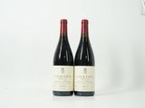 deux bouteilles de vin rouge posées l'une à côté de l'autre sur une table