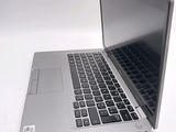 a silver laptop computer sitting on top of a white table