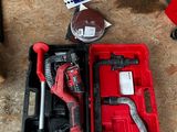 a red tool in a red case on the floor