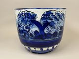 a blue and white bowl with a tree design on it