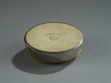 a small silver box with a writing on it