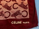 a close up of a red and brown scarf with a picture of a cat on it