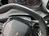 the interior of a car with a steering wheel and dashboard controls