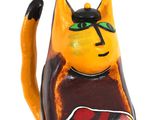 yellow and black cat figurine sitting on a white surface