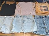a lot of shorts and t - shirts laid out on a table