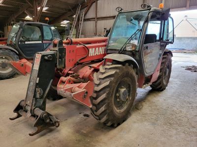 a tractor that is parked in a garage