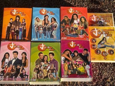 several dvd ' s are stacked on top of each other on the ground
