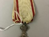 a close up of a medal with a ribbon on a table