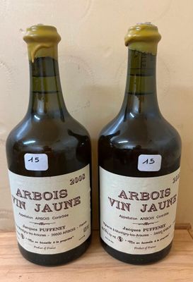 two bottles of wine sitting on top of a wooden table