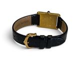 a close up of a black leather bracelet with a gold buckle