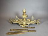 a gold plate with a figurine and a knife on it