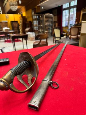 two swords on a red table in a room