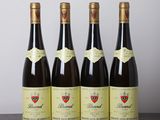 four bottles of wine are lined up on a table