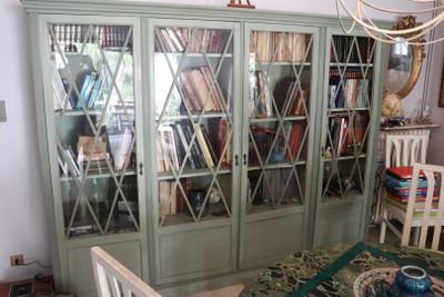 a book case with many books on it in a room