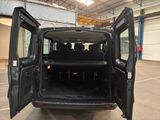 a black van with its doors open in a garage