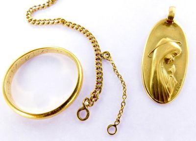 a gold necklace with a picture of a person on it