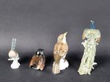 five figurines of birds sitting on top of each other