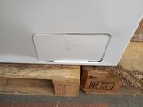 a white refrigerator sitting on a pallet in a warehouse