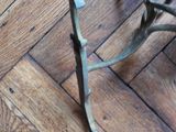 a piece of wood on the floor next to a pair of scissors