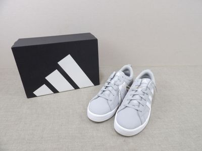 the adidas shoes are on the floor next to a box