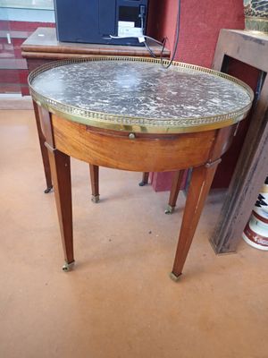 a small table with a marble top in a room