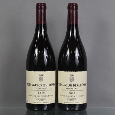 two bottles of wine sitting on top of a table next to each other
